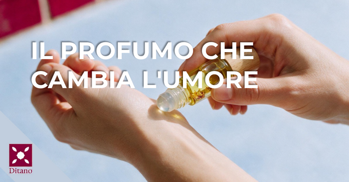 Mano che applica un olio profumato roll-on sul polso in un gesto di benessere